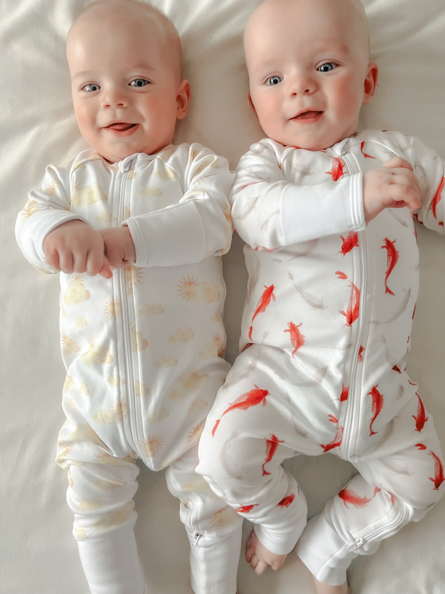 Image of twin boys wearing Organic Microsuits in Golden Solis and Oriental Koi